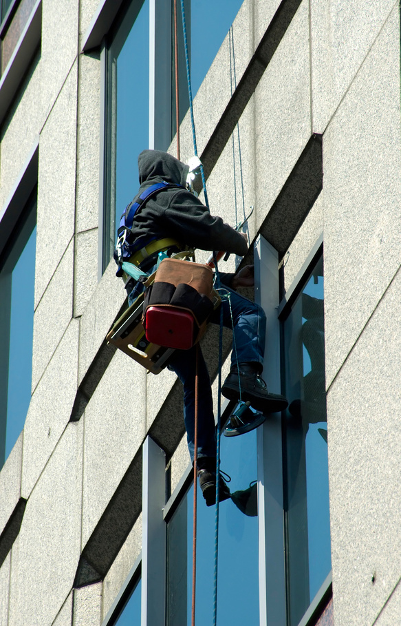 Man fixing windows on rope